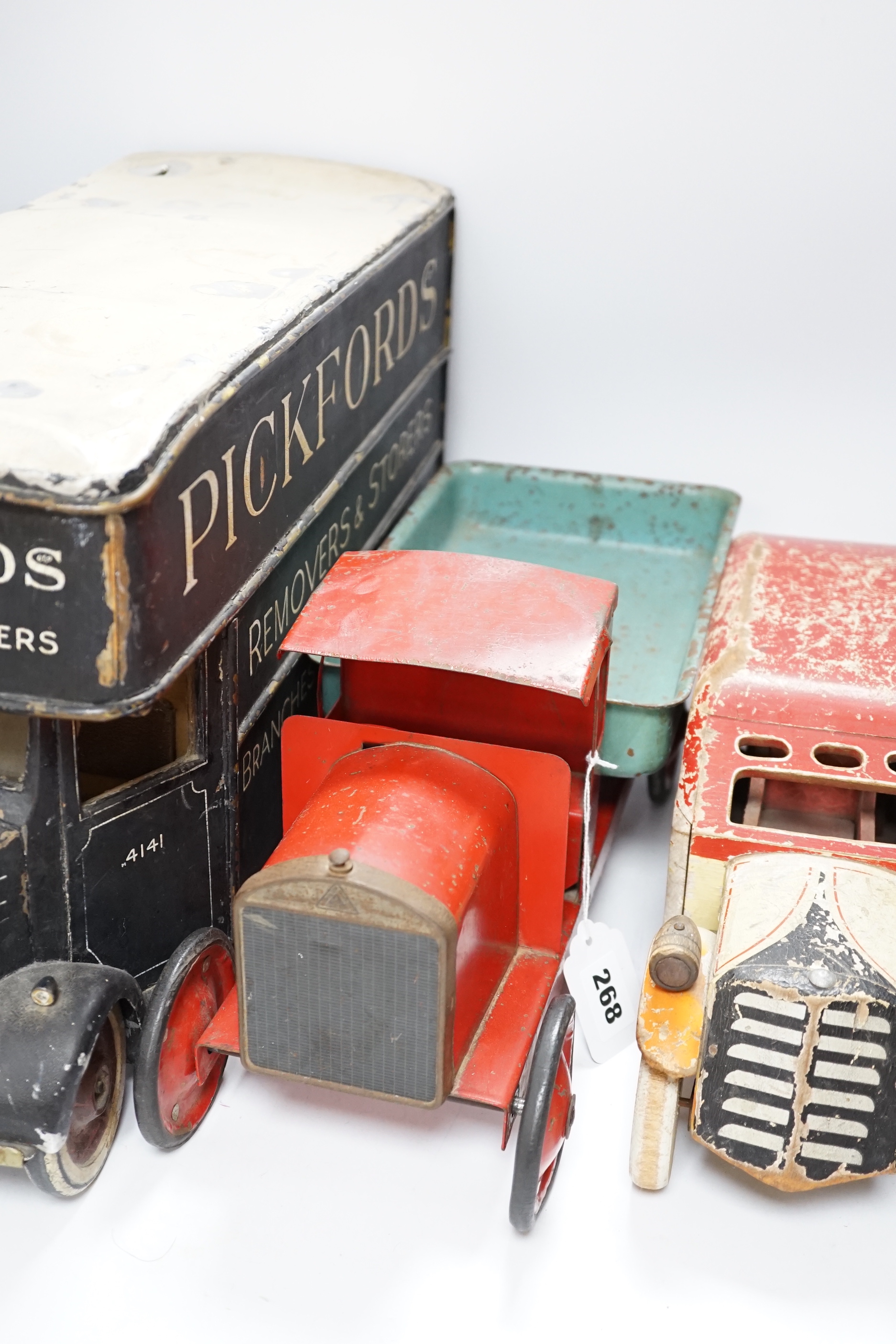 Three model vehicles including; a tinplate Tri-ang tipper lorry, a Pickfords removal van (believed to have been used as a shop window display) and a wooden bus, length of Pickfords van 54cm